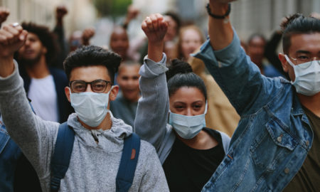 aging out: Group of people wearing face mask protesting