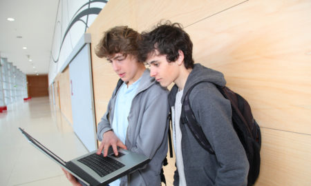 rural: 2 teenage boys at school with laptop