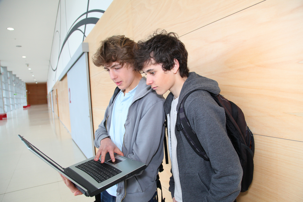 rural: 2 teenage boys at school with laptop 