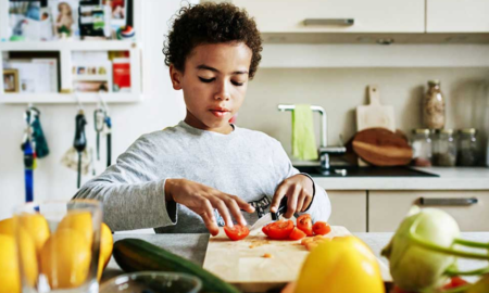 Children's Mental Health and Childhood hunger grants; young child preparing healthy food in kitchen