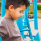 Long Term foster care for unaccompanied immigrant children grants; young ethnic child sitting on playground