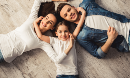 family economic mobility and health; young happy family laying on the floor
