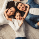 family economic mobility and health; young happy family laying on the floor