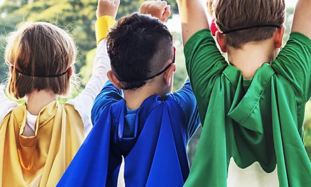 School-Based Healthcare During COVID Support Grants; young children with capes on and arms raised