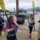 Alaska: 3 kids hold kayak paddles on pier.