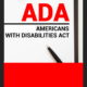 ADA: Paper on clipboard with Americans with Disabilities Act ADA on a table