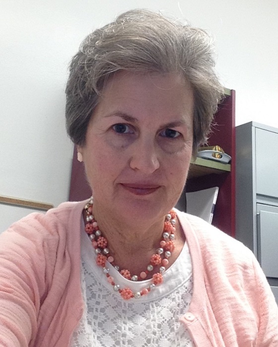 peer-on-peer: Lori Kornblum (headshot), adjunct faculty at Marquette University Law School, woman with short gray hair, peach and white necklace, white top, peach cardigan
