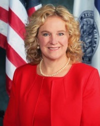 summer learning: Jillian Balow (headshot), Wyoming state superintendent of public instruction, smiling blond woman in pearls wearing red in front of flag