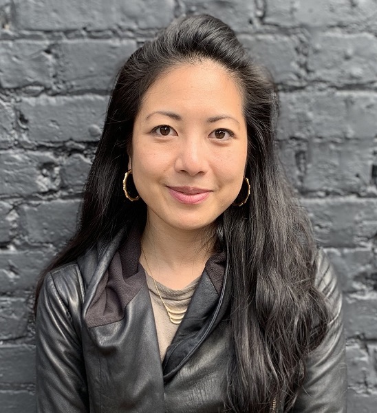 collective: Jessica Fei (headshot), director of programs for Sadie Nash Leadership Project, smiling woman with long black hair, necklace, earrings, black jacket, beige top