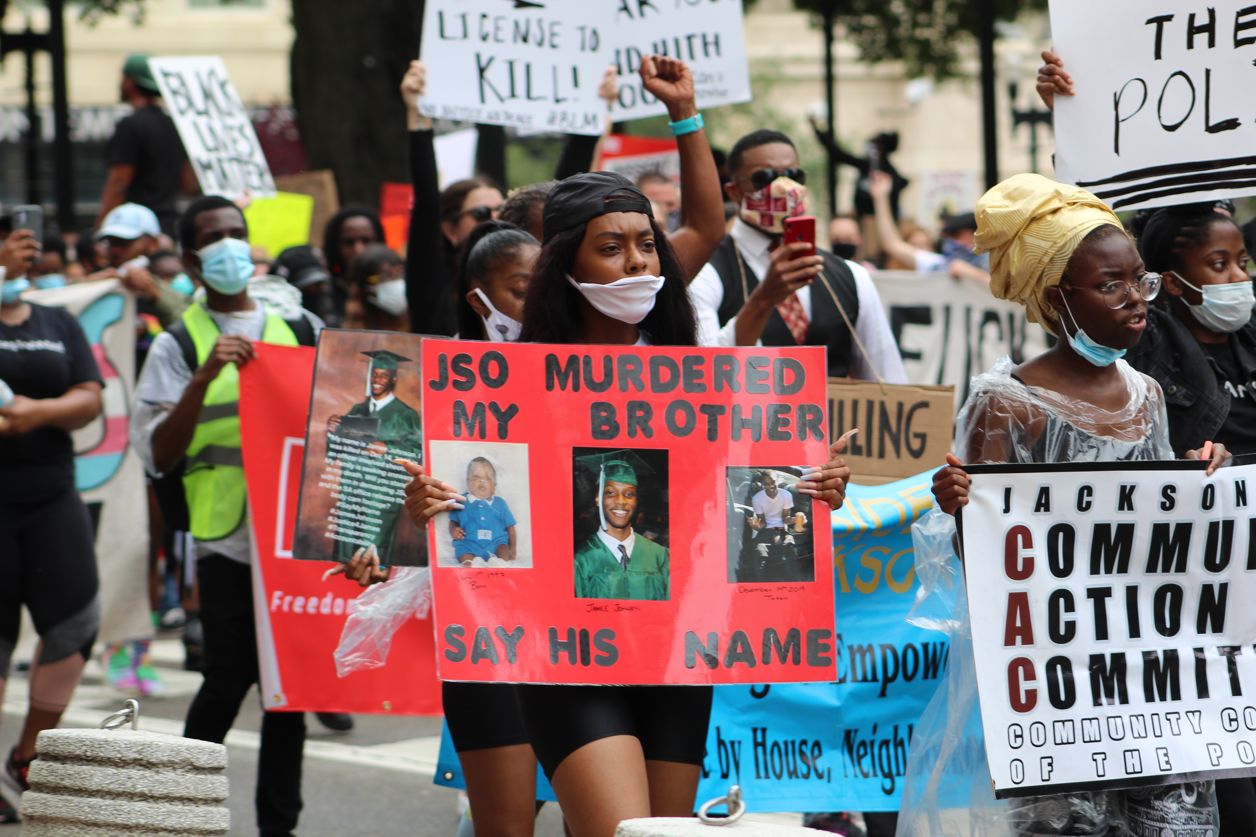 Black Lives Matter Protest Jacksonville: Relative of Jamee Johnson, killed by police in December, carries a sign at a June 6 march and rally in Downtown Jacksonville