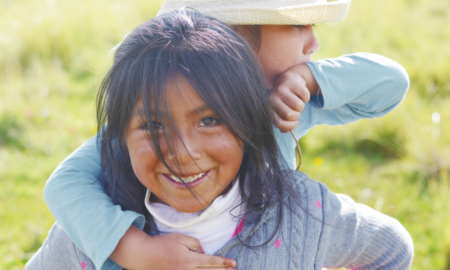 early child care for native families grants; young native girl playing with sibling on back