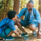 Iowa and Wisconsin community grants; happy father and child spending time in the woods