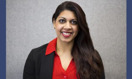 Newsmaker Maheen Kaleem headshot; smiling Pakistani-American woman with suit jacket and red shirt