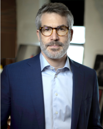 Macon: Thomas Abt - Serious-looking man with graying hair, mustache, beard, wearing glasses, dark blue jacket, light blue shirt.