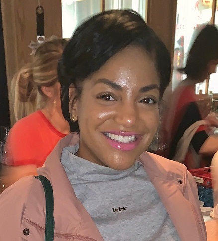 Delbria Walton (headshot), senior policy associate at Forum for Youth Investment, smiling woman with short dark hair wearing peach jacket, gray top