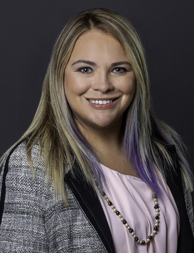 normal: Meghan Bishop (headshot), associate fellow for innovation, technology for Joseph Rainey Center for Public Policy, smiling woman with blond, lilac hair wearing necklace, black and white blazer, pink top