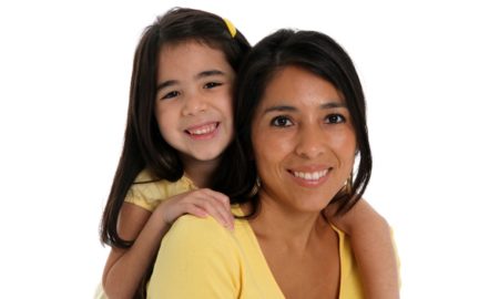Native Community domestic violence grants; native mom and daughter smiling at camera