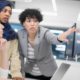 youth fields workforce, mentoring: 3 women, one wearing a hijab, look at computer screen together