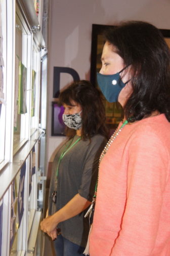 Atlanta school: 2 women wearing masks facing left look through window