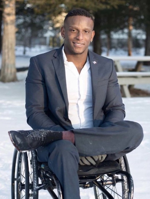 Disabilities habits: smiling dapper man in gray suit, white shirt in wheelchair