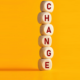future: The word change on wooden cubes against yellow background.