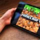 Minecraft: Child playing Minecraft on tablet