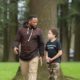Pacific Northwest Disadvantaged Youth Development Program grants; mentor and child walking in outdoors while talking