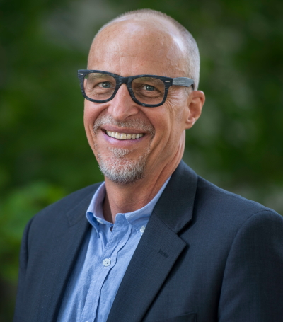 philanthropy: Brian Malte (headshot), executive director of Hope and Heal Fund, smiling bald man with gray beard, mustache wearing glasses, dark blue jacket, light blue shirt