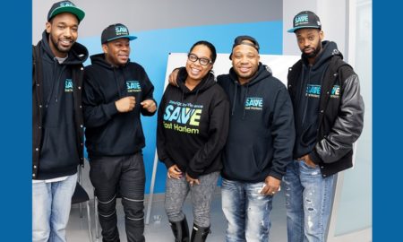 SAVE: 4 men, 1 woman, all smiling, pose in group, all wearing matching sweatshirts that say save east harlem