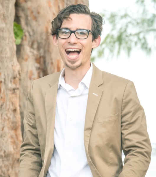 story: Derrick Hatch (headshot), teacher, director of CREATE at Urban Youth Impact, smiling man with short messy brown hair, glasses, wearing beige blazer, white shirt, blue jeans standing next to tree