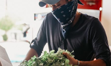 chicago region community food system support grants; man with bandana over face loads fresh food