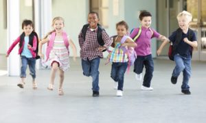 Child wellness and Education grant: Group Of Elementary Age Schoolchildren Running Outside