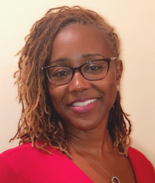Black girls: Macon Stewart (headshot), deputy director for multisystem operations for Center for Juvenile Justice Reform, smiling woman with red mini braids, glasses, earrings, necklace, red top 