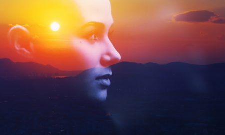youth voice and leadership: Double exposure portrait of a dreamy young woman silhouetted in sky at sunrise.