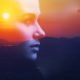 youth voice and leadership: Double exposure portrait of a dreamy young woman silhouetted in sky at sunrise.