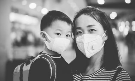Asian American community nonprofit COVID support grants; Asian mother and child in facemasks shopping