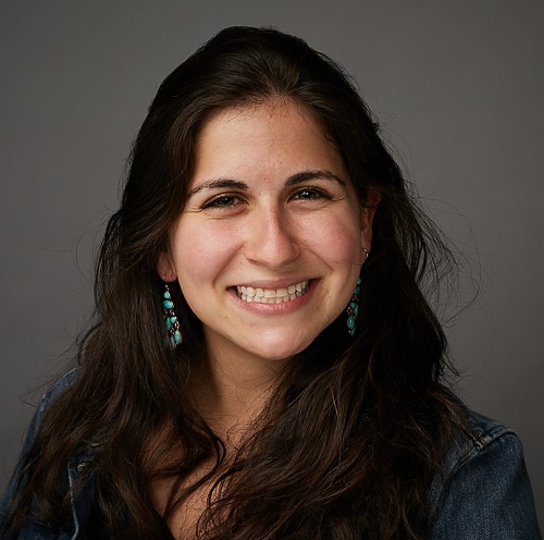 Sarah A. Casper (headshot), freelance writer, smiling woman with long brown hair, earrings