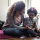 children's mental health program grants; mother talking to child on floor of house