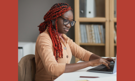 internship: Side view portrait of young African-American woman using laptop