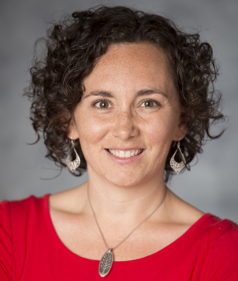 Stephanie Malia Krauss (headshot), senior advisor to JFF, smiling woman with short, brown curly hair, earrings, necklace, red top