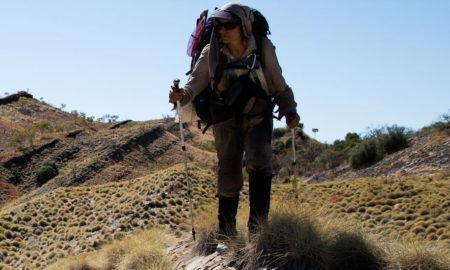 community-based conservation and sustainability during and after covid grants; image of hiker in dry landscape