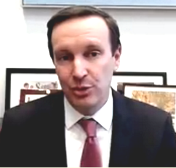 summer learning: Senator Chris Murphy headshot - Man in suit and tie speaking in front of several framed photos