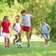 summer learning: 4 kids playing soccer in park