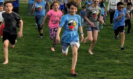 community health equity through sports grants; crowd of children running