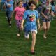 community health equity through sports grants; crowd of children running