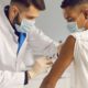 colorado community covid vaccine equity grants; young ethnic man getting vaccine