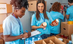 7 Way to Recruit More Volunteers for Your Nonprofit: volunteers packing basic needs goods