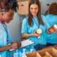 7 Way to Recruit More Volunteers for Your Nonprofit: volunteers packing basic needs goods