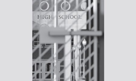 Arrested Learning report cover; high school entrance shown through security gate