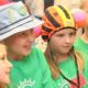 Wyoming community grants: children in different hats at community event